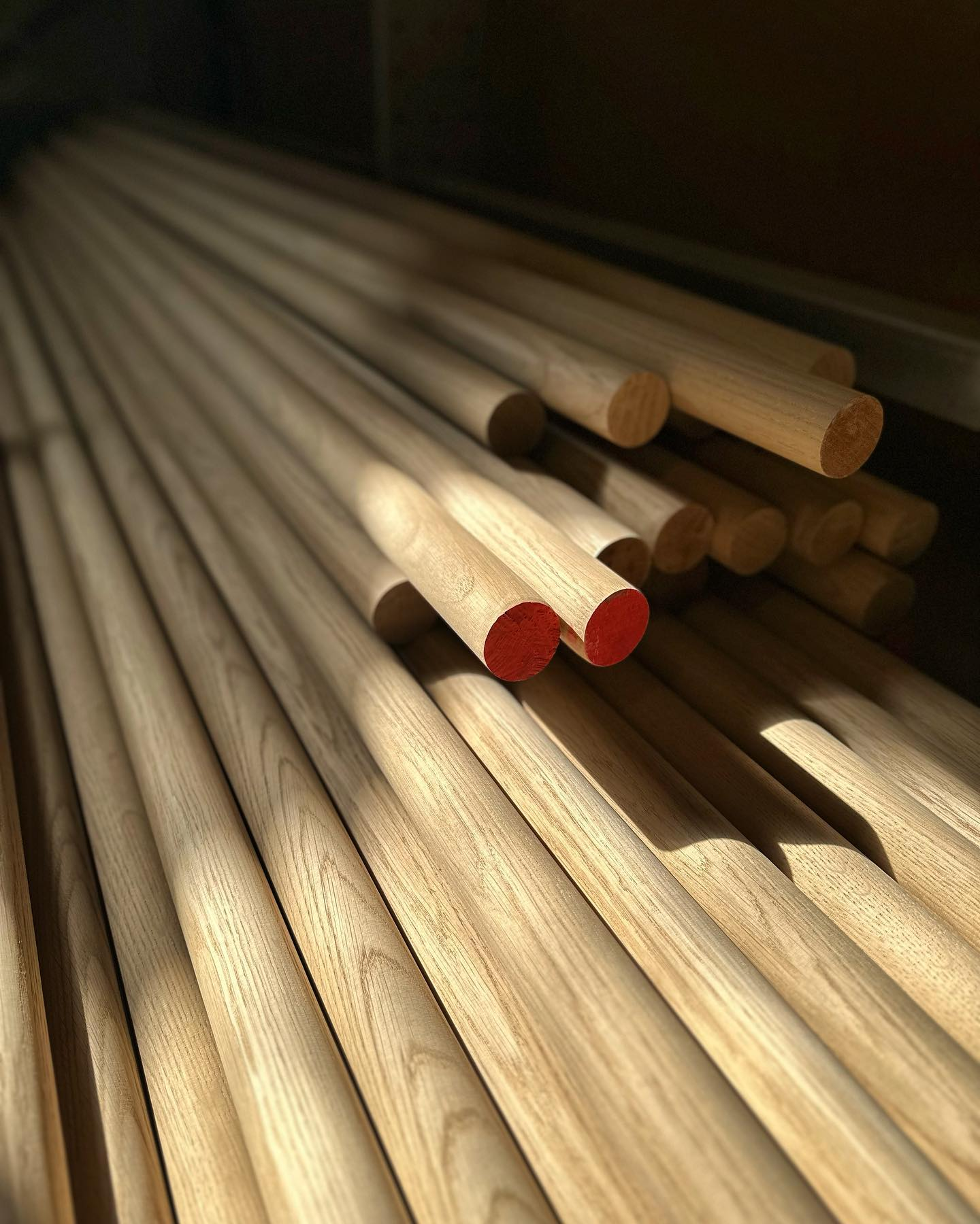 Long oak handrails and rods in workshop storage