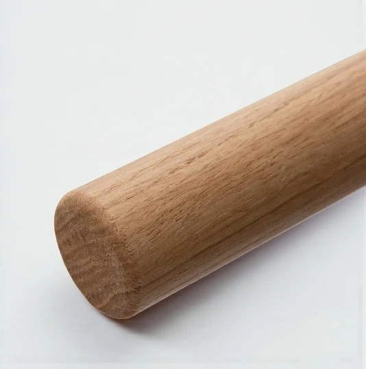 Close-up of a solid oak handrail profile showing natural grain and finish